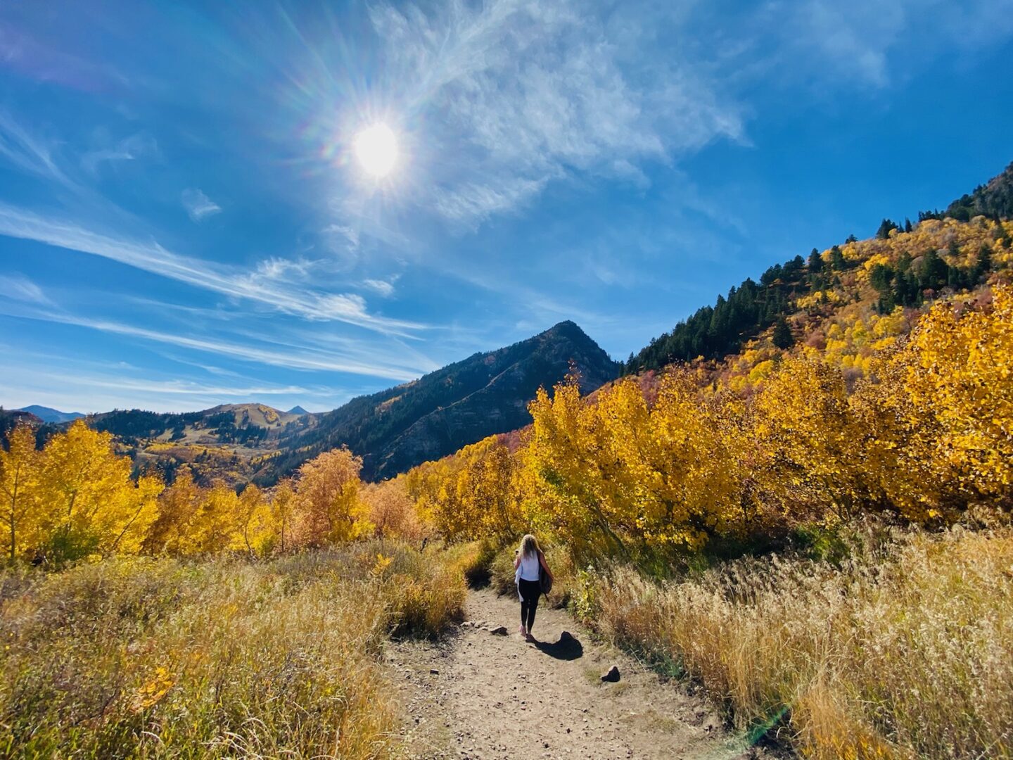 A woman walking on a mountain trail